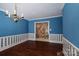 Dining room with blue walls, hardwood floors, and view of the living room fireplace at 2240 Armstrong Park Dr, Gastonia, NC 28054