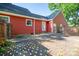 Exterior of red home featuring a brick patio and lush greenery at 2240 Armstrong Park Dr, Gastonia, NC 28054