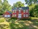 A charming two-story home with an attached two-car garage and a well-manicured front lawn at 2240 Armstrong Park Dr, Gastonia, NC 28054