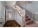 View of the foyer and staircase that features decorative railings and an overhead light fixture at 2240 Armstrong Park Dr, Gastonia, NC 28054