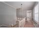 Hallway featuring gray walls, a wooden railing, and views into other rooms at 2240 Armstrong Park Dr, Gastonia, NC 28054