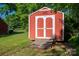 Exterior view of red shed with double doors, surrounded by greenery at 2240 Armstrong Park Dr, Gastonia, NC 28054