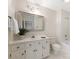 Clean bathroom with large vanity, decorative mirror, toilet, and shower-tub combo at 232 Perrin Pl, Charlotte, NC 28207