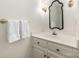 Elegant bathroom with white vanity, decorative mirror, towel rack, and classic fixtures at 232 Perrin Pl, Charlotte, NC 28207