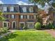 Stately brick home featuring a well-manicured lawn and classic architectural details at 232 Perrin Pl, Charlotte, NC 28207