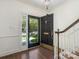 Inviting foyer featuring hardwood floors, a stylish front door, and staircase at 232 Perrin Pl, Charlotte, NC 28207