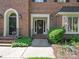 Charming brick home with an inviting front entrance featuring decorative door and manicured landscaping at 232 Perrin Pl, Charlotte, NC 28207