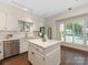 Bright kitchen featuring white cabinets, a center island, stainless steel appliances and natural light at 232 Perrin Pl, Charlotte, NC 28207