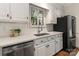 Close up of a kitchen featuring white countertops, stainless steel appliances and a modern faucet at 232 Perrin Pl, Charlotte, NC 28207