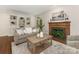 Inviting living room with a fireplace, built-in shelving, and comfortable seating at 232 Perrin Pl, Charlotte, NC 28207