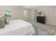 Well-lit main bedroom with a large bed, shuttered windows, ensuite access, and neutral carpet at 232 Perrin Pl, Charlotte, NC 28207