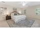 Serene main bedroom featuring a king bed, matching nightstands, and shuttered windows at 232 Perrin Pl, Charlotte, NC 28207
