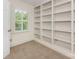 Office space with natural light, built in bookshelf, neutral walls, and carpeted flooring at 232 Perrin Pl, Charlotte, NC 28207