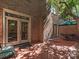 Charming brick patio featuring an outdoor dining set and lush shade trees at 232 Perrin Pl, Charlotte, NC 28207