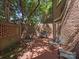 Serene brick patio with comfortable seating and a privacy wall, shaded by mature trees and building overhang at 232 Perrin Pl, Charlotte, NC 28207