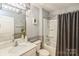 Well-lit bathroom with modern fixtures, sleek vanity, framed mirror, and tub-shower combination at 2772 Sherrills Stream Dr, Sherrills Ford, NC 28673