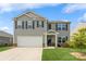 Charming two-story home featuring a well-maintained lawn, a two-car garage, and a welcoming entrance at 2772 Sherrills Stream Dr, Sherrills Ford, NC 28673