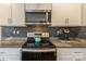 Close up of kitchen featuring granite countertops, stainless steel appliances, and mosaic tile backsplash at 2772 Sherrills Stream Dr, Sherrills Ford, NC 28673