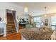 Open kitchen with island, granite countertops, and a view into the living room and staircase at 2772 Sherrills Stream Dr, Sherrills Ford, NC 28673