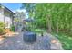 Stone patio in backyard with furniture, fire pit, and lush green landscaping at 3009 Thayer Dr, Waxhaw, NC 28173