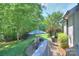 The backyard features a brick patio, grill, and lush landscaping at 3009 Thayer Dr, Waxhaw, NC 28173