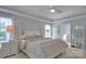 Cozy bedroom showcasing natural light, light-colored walls, and a comfortable bed with decorative pillows at 3009 Thayer Dr, Waxhaw, NC 28173