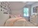 Comfortable bedroom with bed, decorative pillows, and natural light from the window at 3009 Thayer Dr, Waxhaw, NC 28173