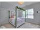 Comfortable bedroom with a four-poster bed, chandelier, and window at 3009 Thayer Dr, Waxhaw, NC 28173