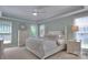 Bright bedroom with neutral tones, featuring a tray ceiling, large windows, and white wood furniture at 3009 Thayer Dr, Waxhaw, NC 28173