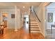 Inviting foyer with hardwood floors, staircase, and views into the living spaces at 3009 Thayer Dr, Waxhaw, NC 28173