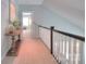Upstairs hallway with a wooden console table and view into the guest room at 3009 Thayer Dr, Waxhaw, NC 28173