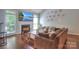Comfortable living room with a fireplace, large TV, and hardwood floors at 3009 Thayer Dr, Waxhaw, NC 28173