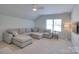 Bright living room area with a large sectional sofa, window, and ceiling fan at 3009 Thayer Dr, Waxhaw, NC 28173