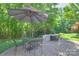 Enjoy this brick patio, outdoor dining set, and fire pit in the backyard at 3009 Thayer Dr, Waxhaw, NC 28173
