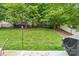 Expansive backyard with mature trees, manicured lawn, and a well-maintained fence at 3032 Kilbeggan Dr, Lake Wylie, SC 29710