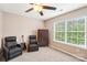 Comfortable bedroom featuring two recliners, neutral walls, large window with natural lighting and storage cabinet at 3032 Kilbeggan Dr, Lake Wylie, SC 29710
