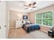 Cozy bedroom featuring a ceiling fan, neutral walls, and a large window view with white dresser at 3032 Kilbeggan Dr, Lake Wylie, SC 29710