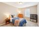Cozy bedroom featuring neutral walls, a large window view with wood dresser and bookcase at 3032 Kilbeggan Dr, Lake Wylie, SC 29710