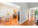 Cozy dining area with hardwood floors, table set for four, and an open view to the kitchen at 3032 Kilbeggan Dr, Lake Wylie, SC 29710