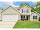 Charming two-story home with light green siding, attached garage, and well-maintained front lawn at 3032 Kilbeggan Dr, Lake Wylie, SC 29710