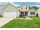Charming two-story home with manicured lawn, lush landscaping, and attached two car garage at 3032 Kilbeggan Dr, Lake Wylie, SC 29710