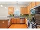 Bright kitchen features stainless steel appliances, wooden cabinets, granite countertops, and a stylish backsplash at 3032 Kilbeggan Dr, Lake Wylie, SC 29710