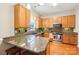 Well-lit kitchen with granite countertops, stainless steel appliances, wooden cabinets, and stylish backsplash at 3032 Kilbeggan Dr, Lake Wylie, SC 29710