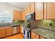 Modern kitchen with granite countertops, stainless steel appliances, and decorative backsplash at 3032 Kilbeggan Dr, Lake Wylie, SC 29710