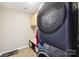 Well-equipped laundry room featuring a new washer/dryer unit, tile flooring and overhead cabinet storage at 3032 Kilbeggan Dr, Lake Wylie, SC 29710