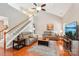 Cozy living room with hardwood floors, vaulted ceilings, ceiling fan, and staircase leading to second floor at 3032 Kilbeggan Dr, Lake Wylie, SC 29710
