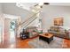 Bright living room with hardwood floors, vaulted ceilings, staircase, and comfortable seating arrangement at 3032 Kilbeggan Dr, Lake Wylie, SC 29710