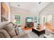 Open-concept living room with hardwood floors, vaulted ceilings, cozy sofas, and natural lighting from windows at 3032 Kilbeggan Dr, Lake Wylie, SC 29710