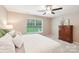 Comfortable main bedroom featuring a window, ceiling fan, dresser, and neutral decor for a relaxing atmosphere at 3032 Kilbeggan Dr, Lake Wylie, SC 29710