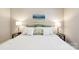 Inviting main bedroom features a bed, bedside tables, lamps, and a beach-themed painting at 3032 Kilbeggan Dr, Lake Wylie, SC 29710